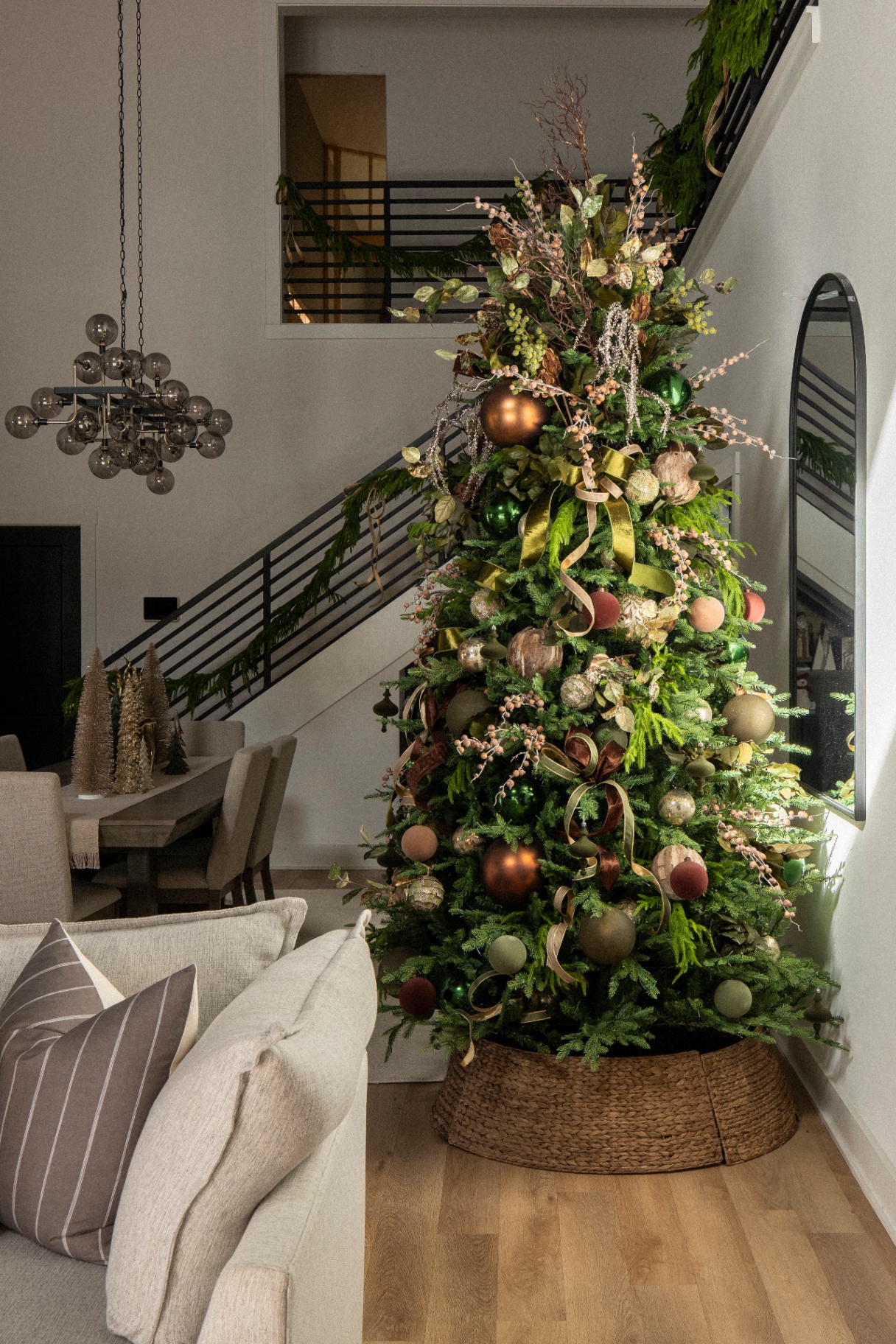 Organic green and bronze Christmas tree in a modern living room