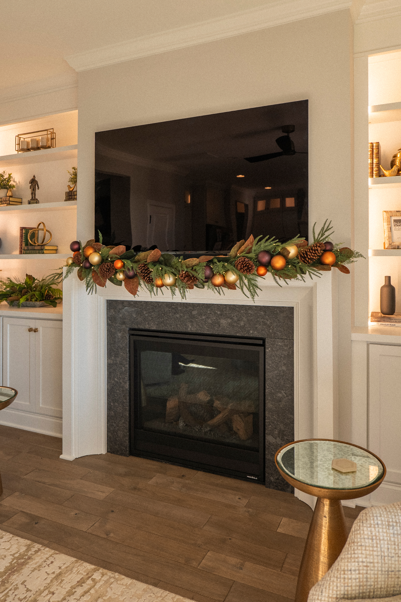 White mantle with magnolia leaves, pinecones, and copper and gold ornament garland