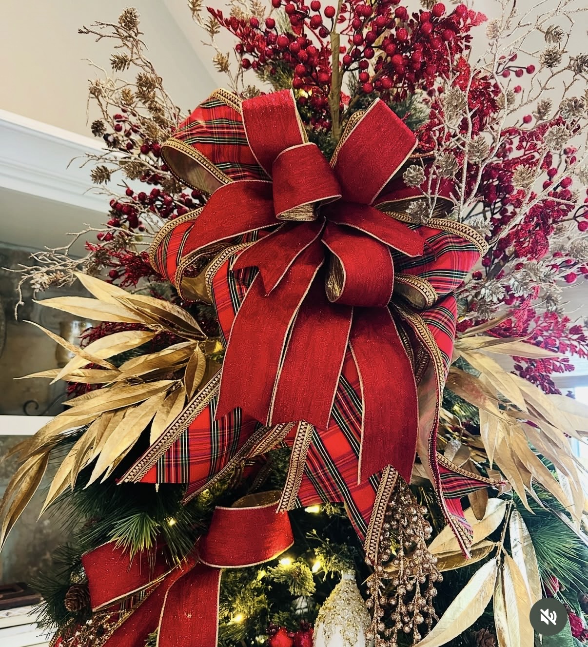 Dramatic red and tartan ribbon tree topper with red berry sprays and gold accents