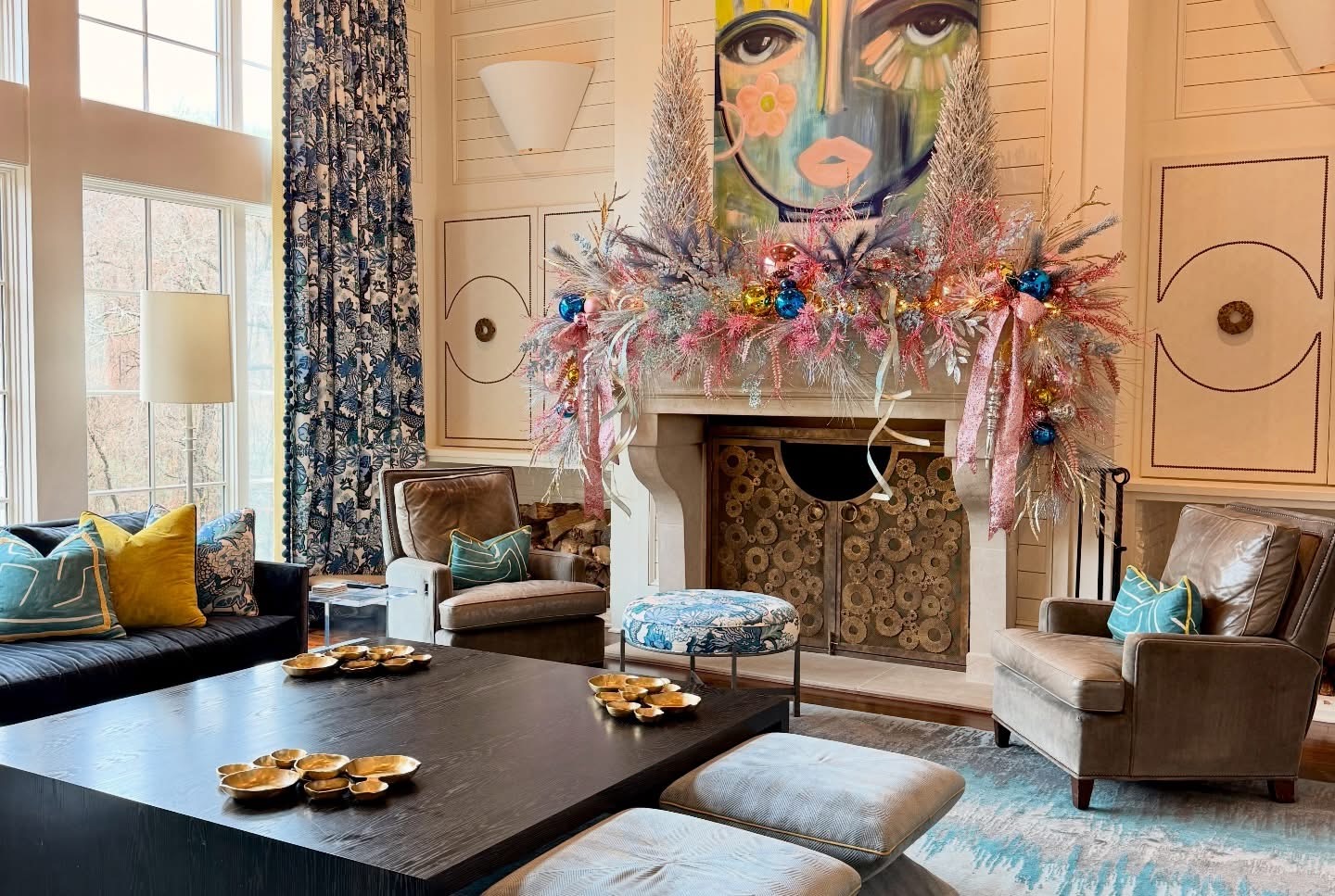 Whimsical pastel tinsel mantle with blue and pink ornaments, glitter ribbon, and tall bottlebrush trees beneath colorful artwork